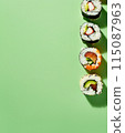 Set of sushi rolls top view over soft green background 115087963