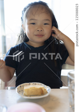 Girl eating cheesecake Girl eating cheesecake 115088023