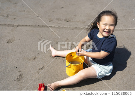 Girls playing at the beach 115088065