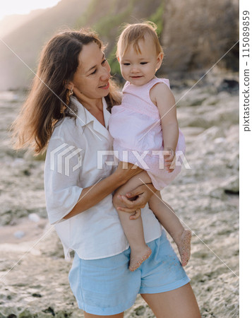 Cute child girl eat apple fruit. Little girl close up in summer garden. Cute child girl eat apple fruit. Little girl close up in summer garden. 115089859