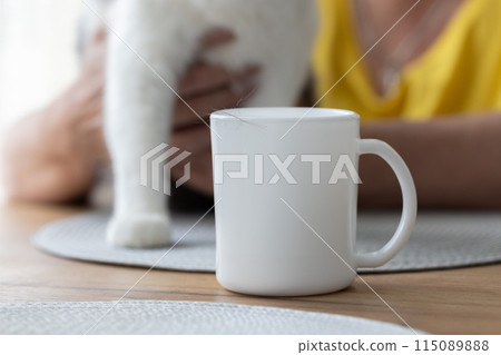 Domestic cat during the moult. Cats hair on the cup of tea. Domestic cat during the moult. Cats hair on the cup of tea. 115089888