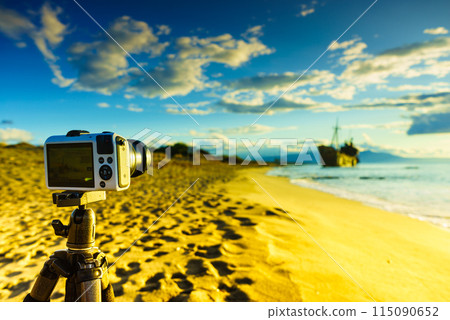 Camera on tripod and shipwreck 115090652