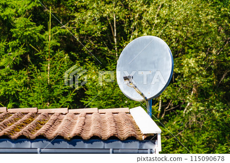 Satellite dish on roof of house 115090678