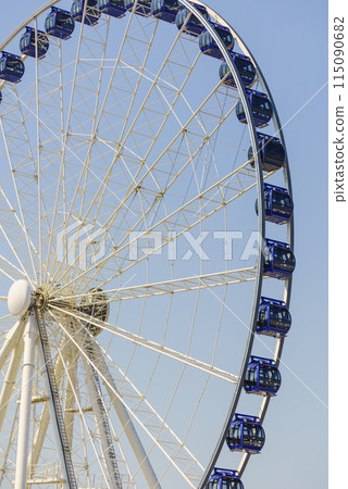 Ferris wheel on blue sky 115090682