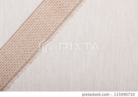 Jute ribbon on linen cloth background 115090710