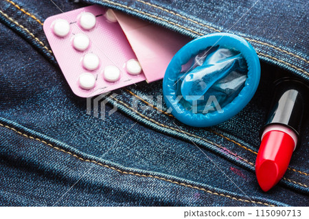 Pills condom and lipstick in denim pocket. Pills condom and lipstick in denim pocket. 115090713