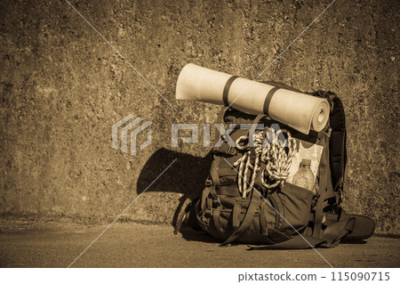 Hiking backpack camping equipment outdoor on grunge wall 115090715