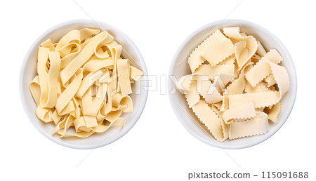 Two types of short thick ribbon pasta, uncooked durum wheat semolina noodles with egg, Italian laminated pasta in white bowls. Smooth ribbons, called sagnette, and serrated ribbons, called rustiche. Two types of short thick ribbon pasta, uncooked durum wheat semolina noodles with egg, Italian laminated pasta in white bowls. Smooth ribbons, called sagnette, and serrated ribbons, called rustiche. 115091688