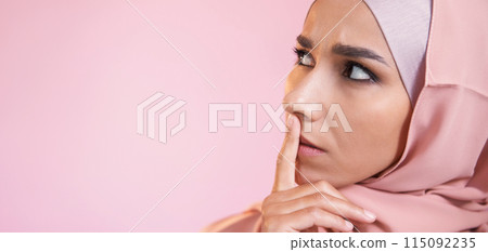 Worried face. Overwhelmed expression. Portrait of disturbed perplexed scared woman in muslim headscarf isolated on pink empty space background. 115092235