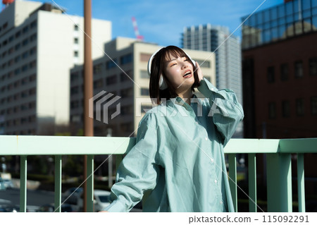 Woman singing with headphones on Woman singing with headphones on 115092291