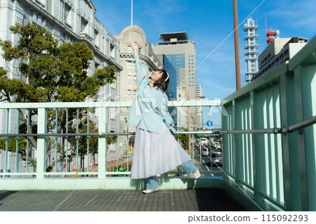 Woman dancing with headphones on Woman dancing with headphones on 115092293