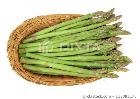 fresh asparagus in in a wicker basket isolated on white background. Top view. Flat lay. 115093173