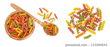 raw Fusilli colored pasta in wooden bowl isolated on white background with full depth of field. Top view. Flat lay raw Fusilli colored pasta in wooden bowl isolated on white background with full depth of field. Top view. Flat lay 115094643