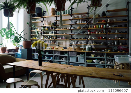 No people shot of modern pottery workshop interior with wooden furniture and ceramic products on shelves, copy space 115096607