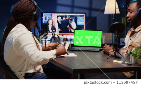 Isolated screen laptop on desk next to presenter on podcast chatting with guest during marathon stream for humanitarian cause. Chroma key notebook used by host to check gathered donations from fans 115097457