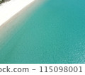 Aerial view of a blue sea surface water texture background and sun reflections Aerial flying drone view water surface texture on sunny tropical ocean 115098001