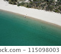 Aerial view of a blue sea surface water texture background and sun reflections Aerial flying drone view water surface texture on sunny tropical ocean 115098003