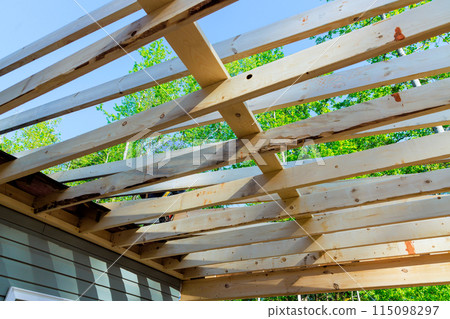 During remodeling of house, wooden trusses were installed in place of unfinished framing beams 115098297