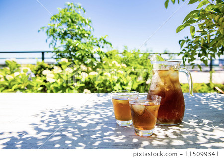 Barley tea, Japanese summer drink, photographed in the shade of a tree in the garden Barley tea, Japanese summer drink, photographed in the shade of a tree in the garden 115099341