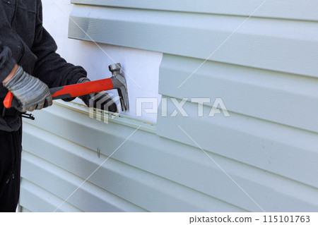 Reconstruction of exterior of house includes replacement of damaged plastic siding 115101763