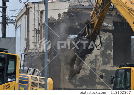 Demolition site: A factory being demolished with heavy machinery Demolition site: A factory being demolished with heavy machinery 115102507