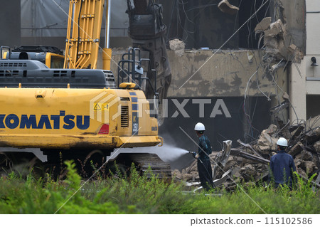 Demolition site: A factory being demolished with heavy machinery Demolition site: A factory being demolished with heavy machinery 115102586