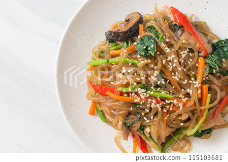 japchae or stir-fried Korean vermicelli noodles with vegetables and pork topped with white sesame 115103681