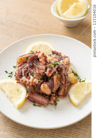 grilled octopus or squid with butter lemon sauce grilled octopus or squid with butter lemon sauce 115104016
