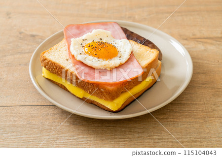 bread toasted cheese topped ham and fried egg with pork sausage 115104043