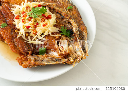 Fried Sea Bass Fish with Fish Sauce and Spicy Salad 115104080