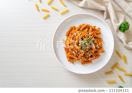 spirali or spiral pasta with tomato sauce 115104151