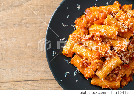 Rigatoni pasta bolognese with cheese Rigatoni pasta bolognese with cheese 115104191