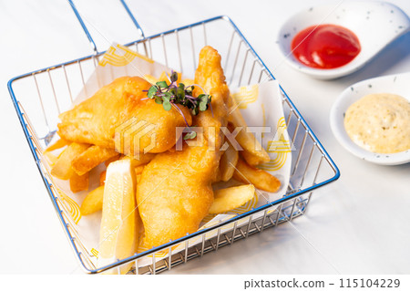 fish and chips in basket with sauce fish and chips in basket with sauce 115104229