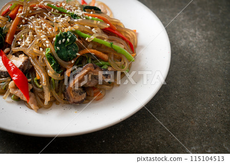 japchae or stir-fried Korean vermicelli noodles with vegetables and pork topped with white sesame 115104513