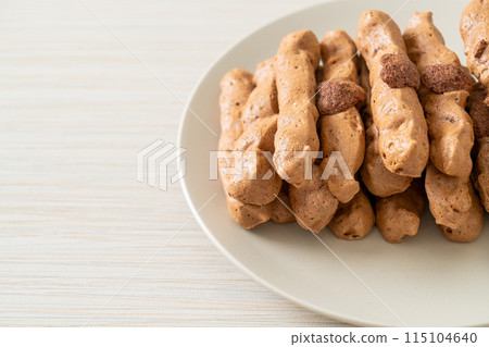 chocolate meringue stick on plate 115104640