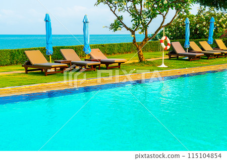 chair pool  or bed pool and umbrella around swimming pool with sea background 115104854