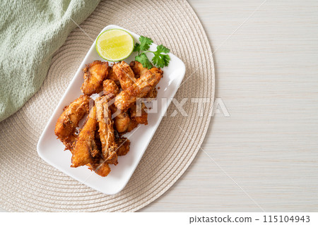 Fried Snapper Belly on white plate Fried Snapper Belly on white plate 115104943