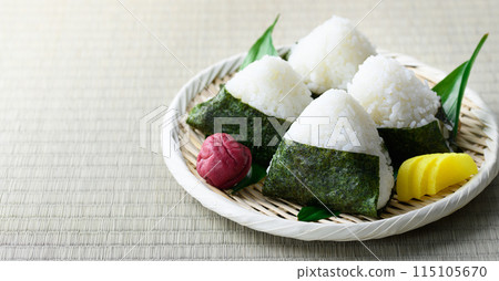 Rice balls wrapped in roasted seaweed and traditional sour pickled plums eaten on tatami mats Rice balls wrapped in roasted seaweed and traditional sour pickled plums eaten on tatami mats 115105670