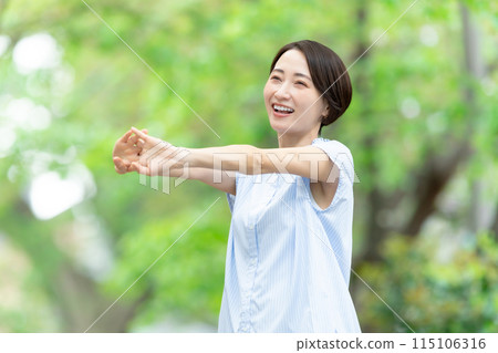 Woman stretching deep breathing exercise fresh green Woman stretching deep breathing exercise fresh green 115106316