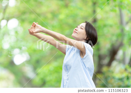 Woman stretching deep breathing exercise fresh green Woman stretching deep breathing exercise fresh green 115106323