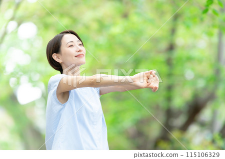 Woman stretching deep breathing exercise fresh green Woman stretching deep breathing exercise fresh green 115106329