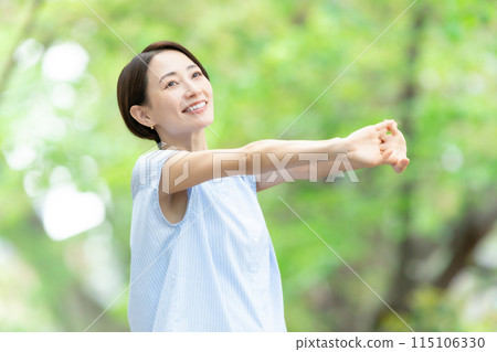 Woman stretching deep breathing exercise fresh green Woman stretching deep breathing exercise fresh green 115106330