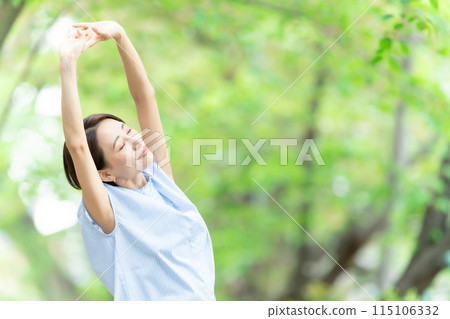 Woman stretching deep breathing exercise fresh green 115106332