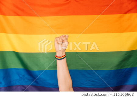 Fist with pride strap in front of LGBT flag Fist with pride strap in front of LGBT flag 115106668