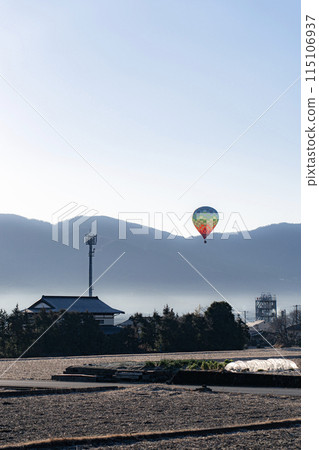 Hot air balloon flying over the countryside (vertical) 115106937