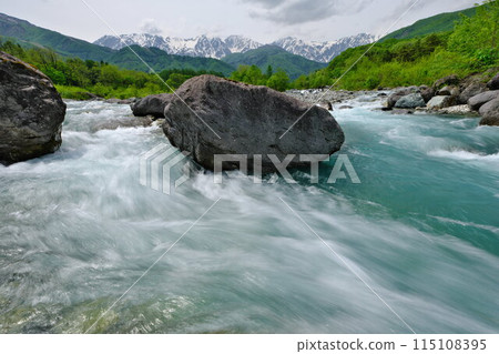 Spring in Hakuba Village The riverbank of Hakuba Ohashi Bridge The turquoise waters of the Matsukawa River flowing from the Northern Alps 115108395