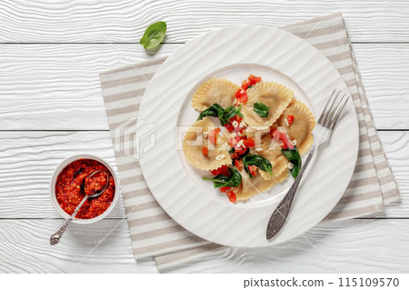 italian pasta mezzelune on a plate, top view italian pasta mezzelune on a plate, top view 115109570