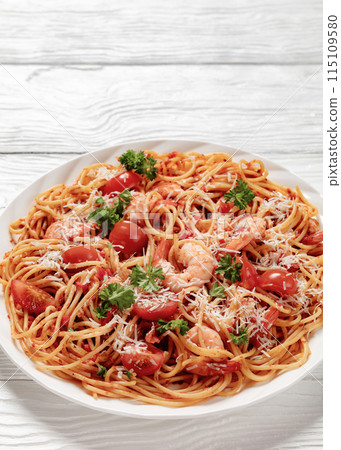 shrimp fra diavolo with spaghetti on a plate 115109580
