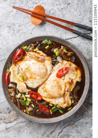 Sweet sour soy sauce egg telur masak kicap closeup on the plate. Vertical top view 115109943