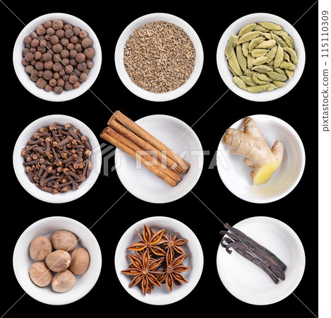 Christmas spices and the scents of winter holidays, in white bowls, on black background. Allspice, anise seed, cardamom, cloves, cinnamon bark, fresh ginger, nutmeg, star anise and vanilla pods. 115110309